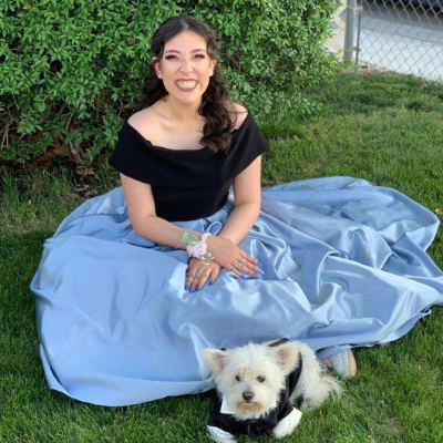 Ashley posing in a dress with her dog